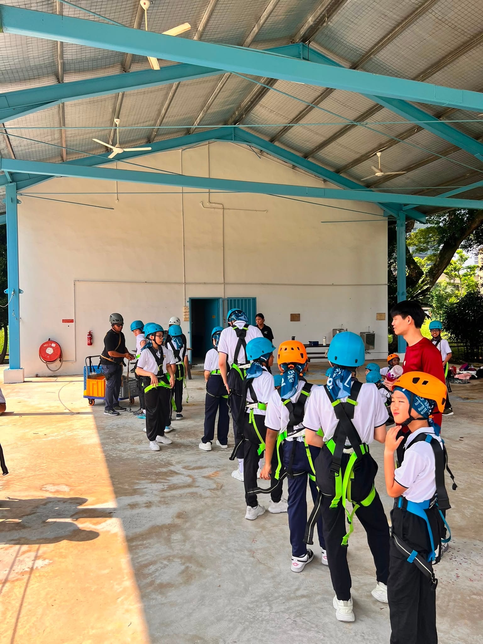 Helmets on, harnesses checked, queue formed for the ropes course ahead.